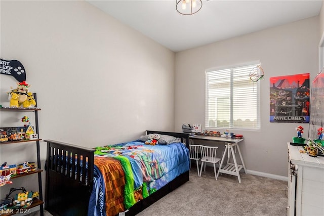 bedroom with light carpet and baseboards