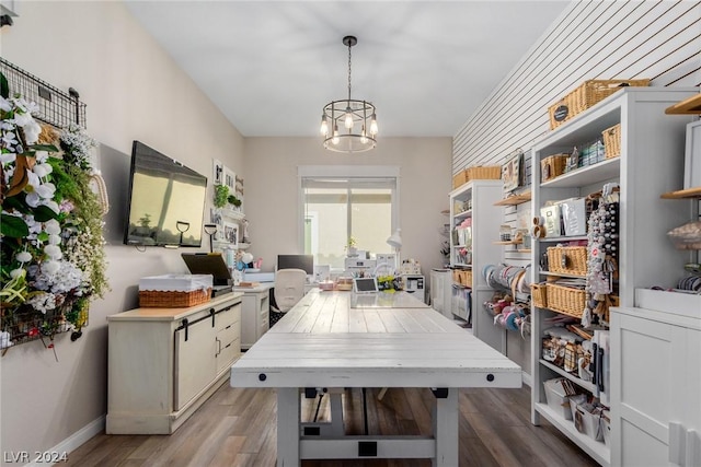 dining room with baseboards, an inviting chandelier, and wood finished floors