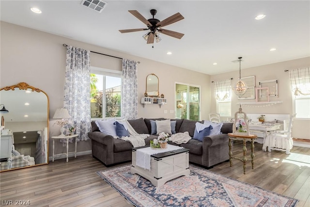 living area with visible vents, wood finished floors, and recessed lighting