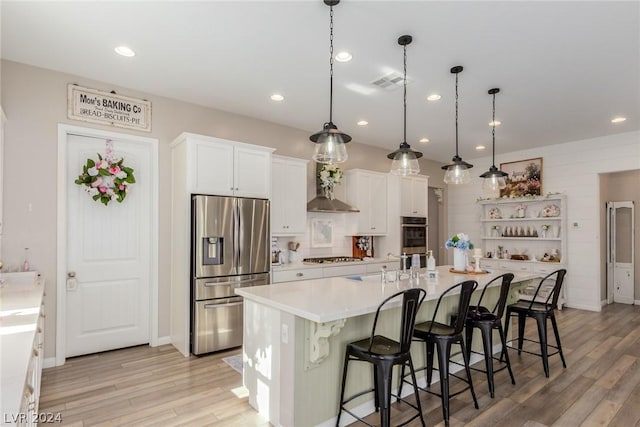 kitchen with white cabinetry, light countertops, appliances with stainless steel finishes, a large island with sink, and pendant lighting