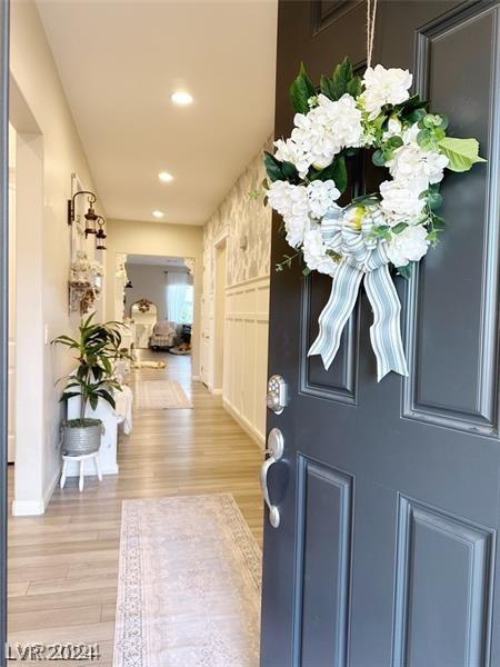 foyer featuring light wood finished floors, baseboards, and recessed lighting