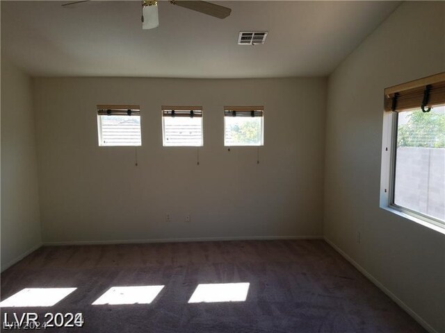 empty room with ceiling fan, carpet, and plenty of natural light