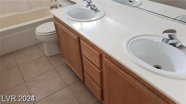 full bathroom featuring dual vanity, shower / bath combination, toilet, and tile patterned floors