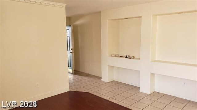 spare room featuring light tile patterned flooring