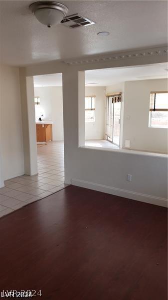 unfurnished room with a wealth of natural light and hardwood / wood-style flooring