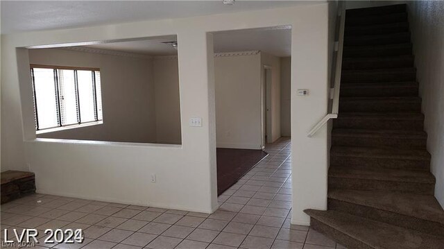 staircase featuring light tile patterned floors