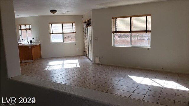 interior space with light tile patterned flooring and a wealth of natural light