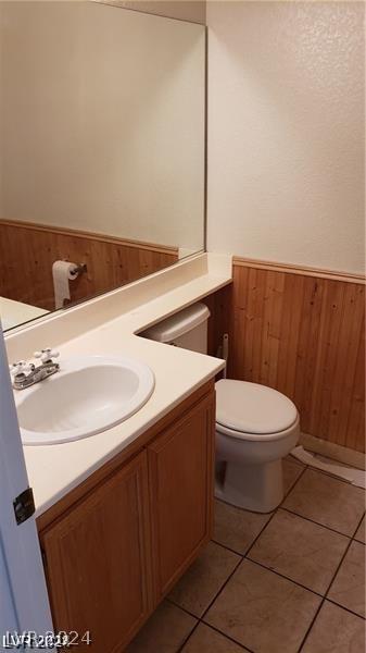 bathroom featuring vanity, tile patterned flooring, and toilet