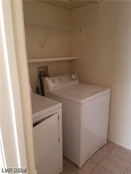 washroom featuring light tile patterned flooring and washer and clothes dryer