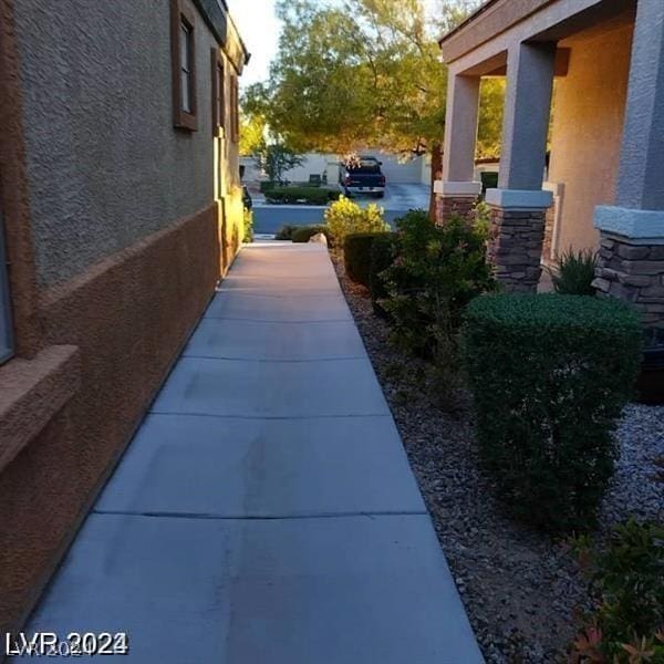 view of side of property with stucco siding and stone siding