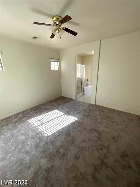 empty room with light colored carpet, visible vents, and ceiling fan