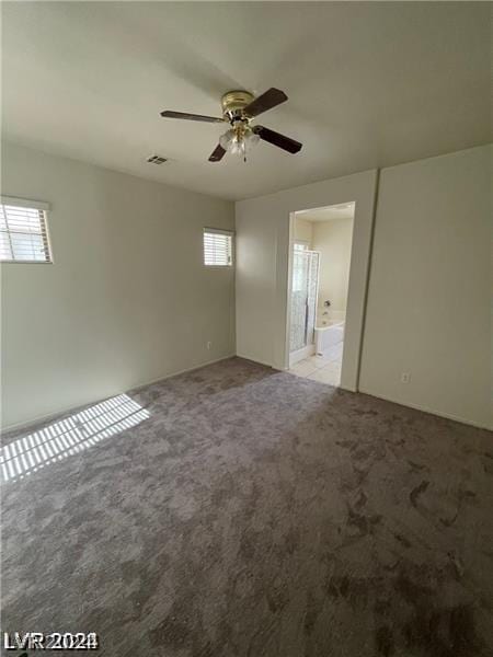 unfurnished room with light carpet, visible vents, and ceiling fan