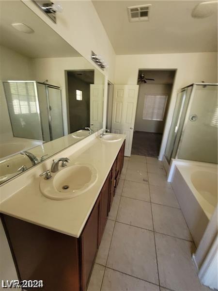 bathroom featuring visible vents, a shower stall, a garden tub, tile patterned floors, and a sink