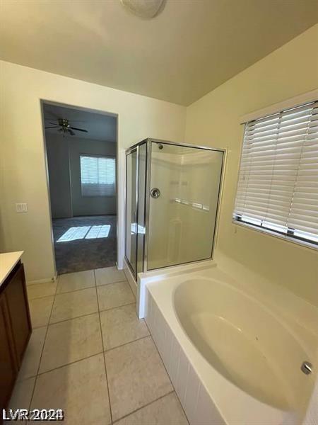 bathroom with vanity, a ceiling fan, tile patterned flooring, a shower stall, and a bath