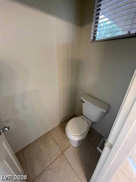 bathroom with tile patterned flooring and toilet