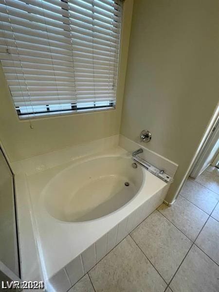 full bathroom featuring tile patterned flooring and a garden tub