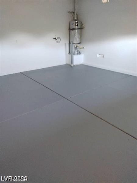 interior space featuring secured water heater and concrete flooring