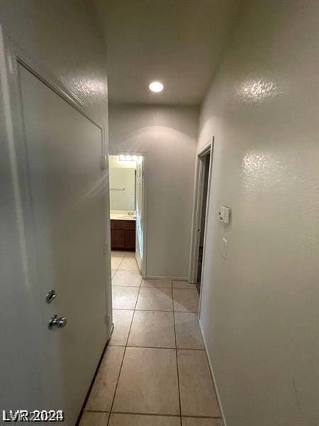 hallway featuring light tile patterned floors and recessed lighting