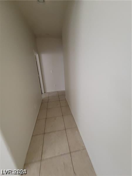 hall featuring light tile patterned floors