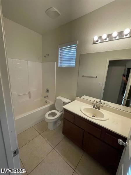 full bathroom featuring tile patterned flooring, shower / bathing tub combination, toilet, and vanity