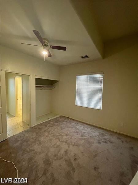 unfurnished bedroom with light colored carpet, visible vents, a closet, and ceiling fan