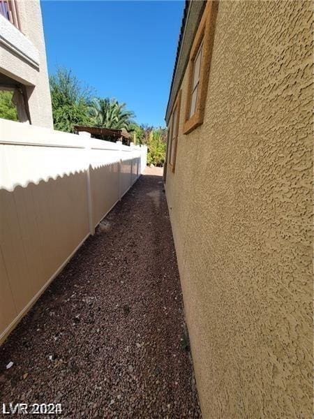 exterior space with fence and stucco siding