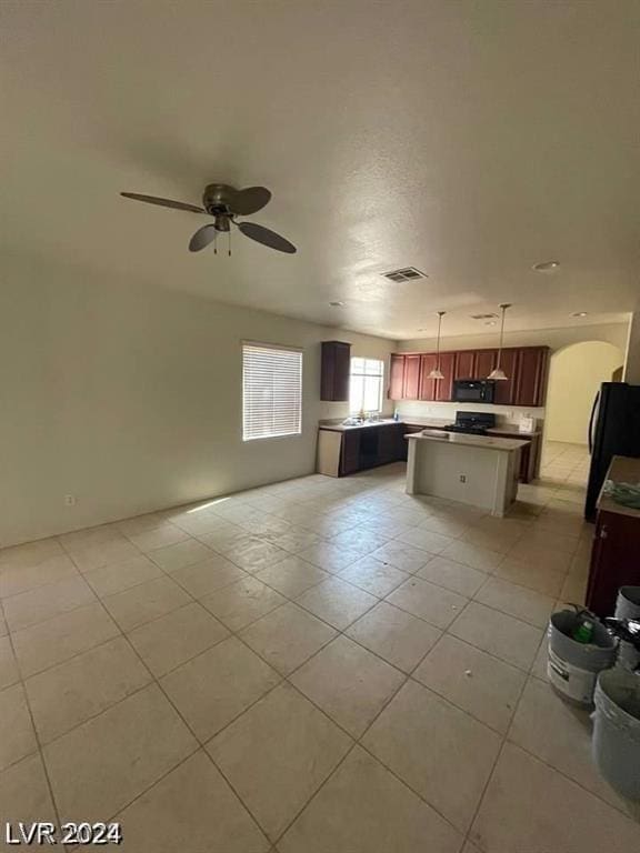 kitchen with a center island, ceiling fan, decorative light fixtures, open floor plan, and black appliances