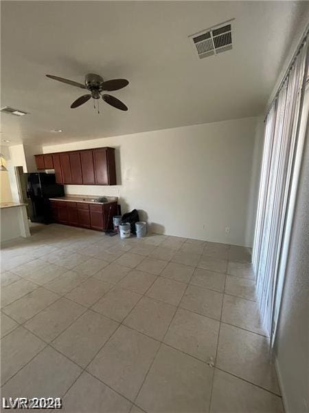 kitchen featuring visible vents, open floor plan, light tile patterned flooring, light countertops, and ceiling fan