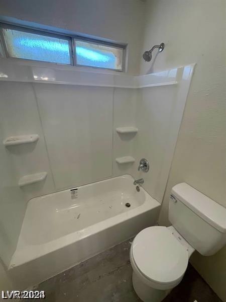 bathroom with toilet and  shower combination