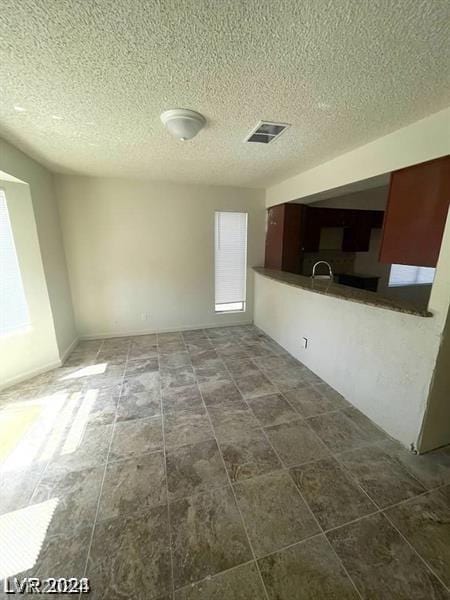 interior space with a textured ceiling