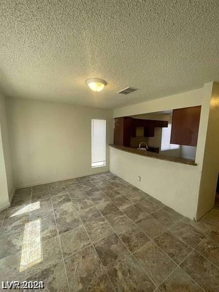 unfurnished living room featuring a textured ceiling