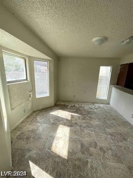 spare room with a textured ceiling