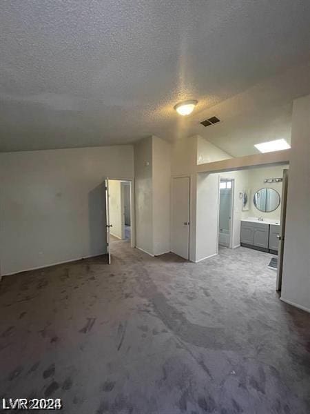 empty room featuring carpet flooring and a textured ceiling