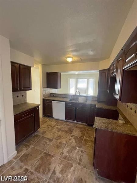 kitchen with dishwasher, sink, decorative backsplash, dark brown cabinetry, and light stone countertops