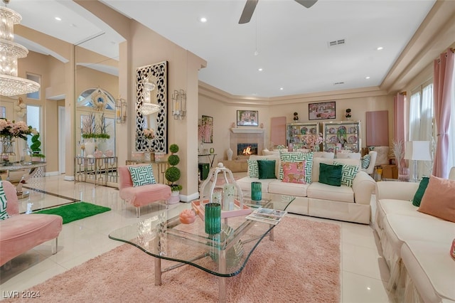 living room with ceiling fan with notable chandelier and light tile patterned floors