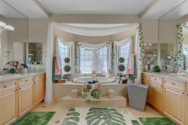 bathroom with vanity, tiled tub, and tile patterned floors