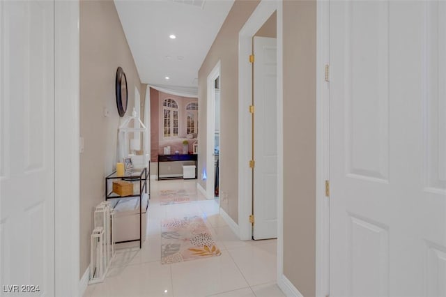 corridor featuring light tile patterned floors