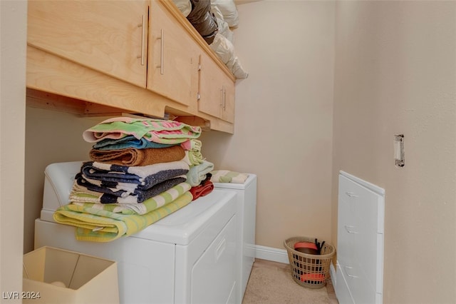 laundry room featuring cabinets and washing machine and dryer