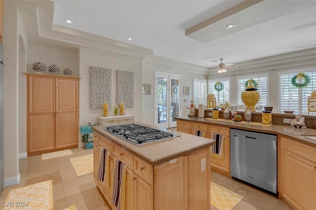 kitchen featuring french doors, a center island, stainless steel appliances, and light brown cabinetry