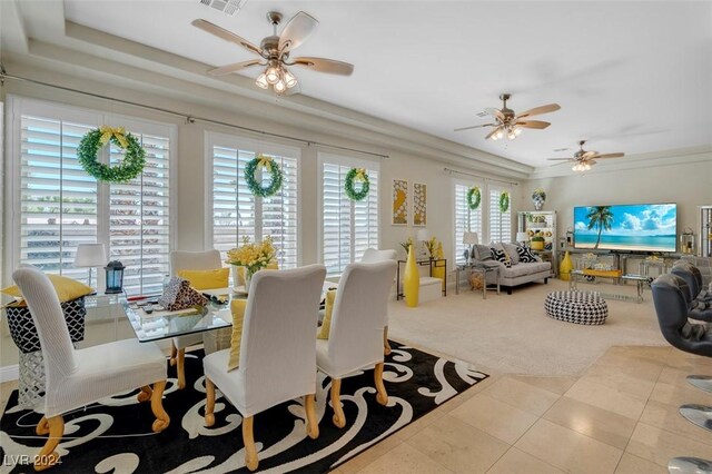 tiled dining area featuring ceiling fan and plenty of natural light