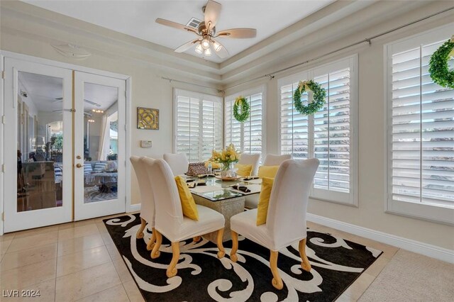 tiled dining room with french doors, ceiling fan, and a wealth of natural light