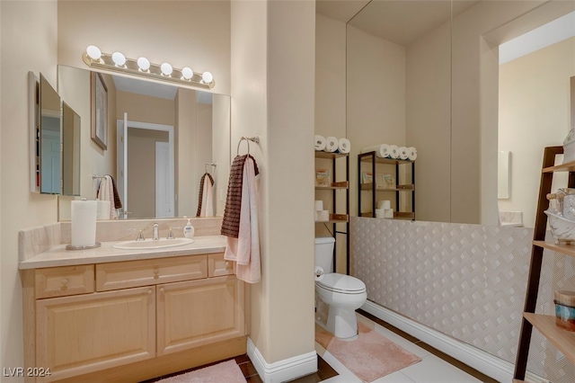 bathroom featuring vanity, tile patterned floors, and toilet