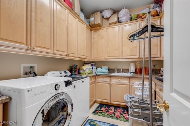 laundry area featuring cabinets, light tile patterned flooring, separate washer and dryer, and sink