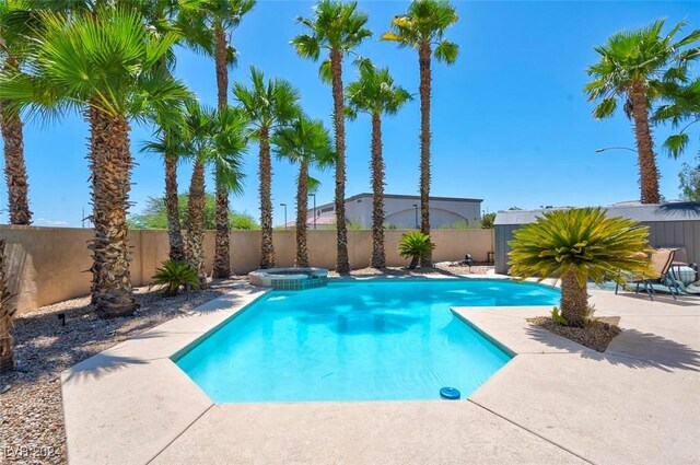 view of pool with a patio area and an in ground hot tub