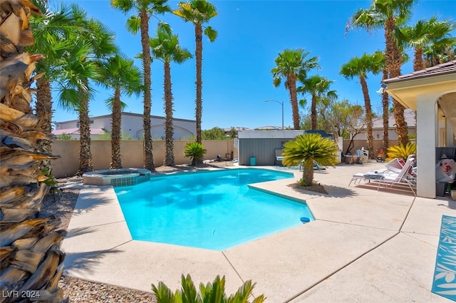 view of swimming pool with an in ground hot tub and a patio