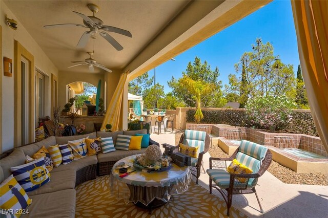 view of patio with outdoor lounge area, exterior bar, and ceiling fan