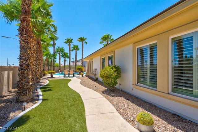 view of yard with a fenced in pool and a patio