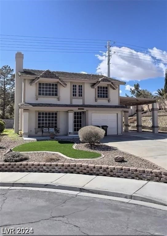 traditional-style home featuring concrete driveway, a chimney, a garage, and stucco siding