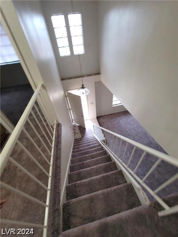 stairs featuring a high ceiling