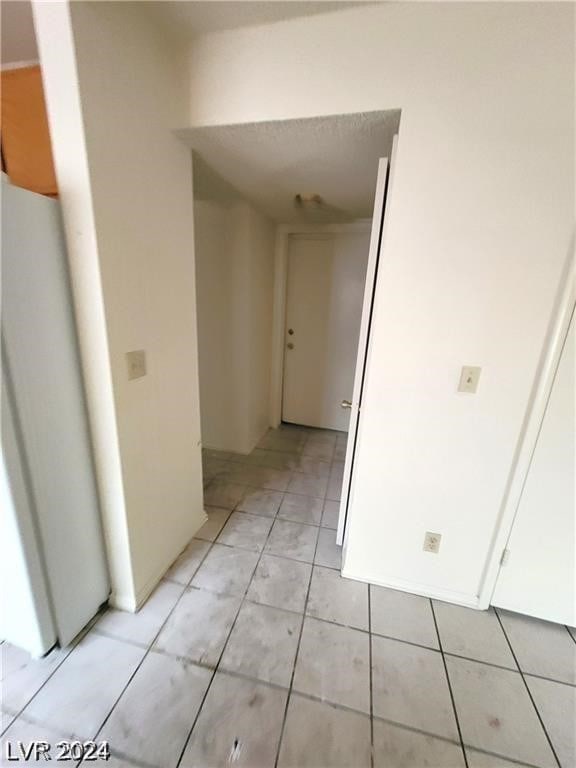 corridor featuring light tile patterned floors